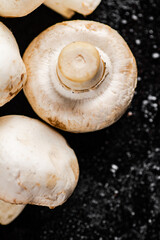 Fresh mushrooms champignons on the table. 