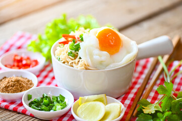 noodles bowl with boiled egg vegetable spring onion lemon lime lettuce celery and chili on wooden table food , instant noodles cooking tasty eating with bowl - noodle soup