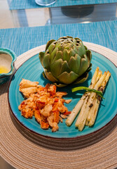 Dinner of Maine Lobster in butter, white asparagus with basil, and artichoke