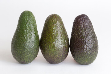 Whole avocados on white background