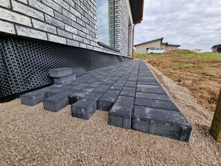 Black concrete brick pavement during laying process
