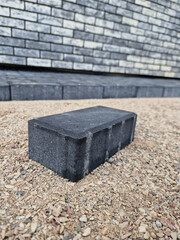 Black concrete brick pavement during laying process