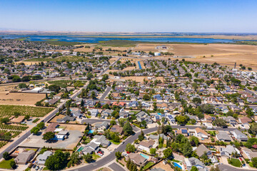 Drone photos over a community in Northern California. With houses, trees and a blue sky