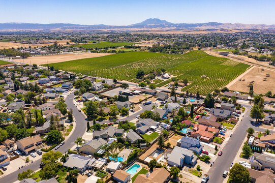 Drone photos over a community in Northern California. With houses, trees and a blue sky