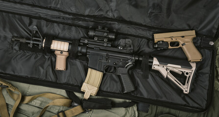 Fototapeta Weapons and military equipment for army, Assault rifle gun (M4A1) and handgun 9mm on rifle case. obraz