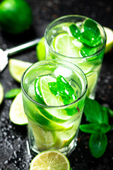 Mojito with mint castings. Against a dark background.