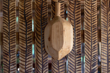 Wooden tray hanging on the wall decorated with stripes. Brazilian craftsmanship