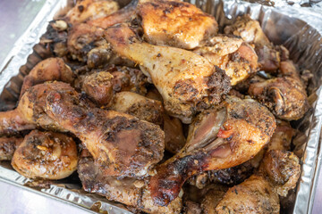 grilled chicken thighs ready to eat at a party