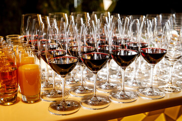 Glasses with red wine on a buffet table.