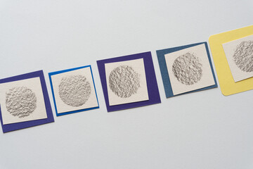 row of textured circle shapes on square cards