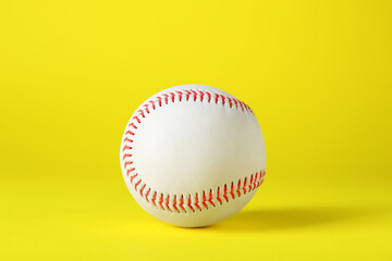 Baseball ball on yellow background. Sports game