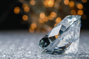 Large dazzling brilliant on shiny surface against blurred festive lights, space for text