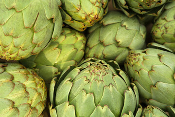 Fototapeta premium Many fresh raw artichokes as background, top view