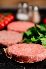 Raw burger with tomatoes and parsley. 