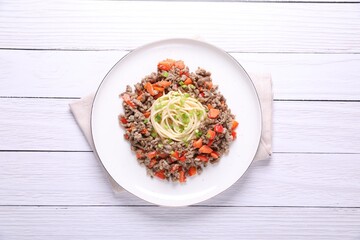 Tasty minced meat with spaghetti, vegetables and green onion on white wooden table, top view
