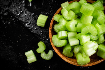 Pieces of fresh celery in a wooden plate. 