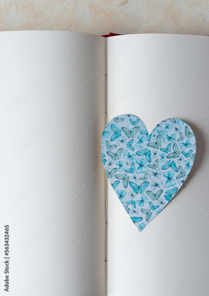 Poster scrapbook paper heart on open book with blank pages