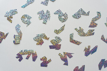 silver glitter paper shapes on blank paper