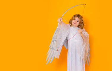 Banner. Little angel with bow and arrow. Cute angel child, studio portrait. Angel kid with angels...
