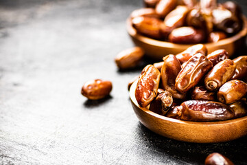 Two plates of dates on the table. 