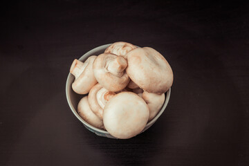 Champignons on a black background. Vegan foods