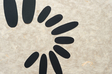 grungy cut paper shapes (mostly oval or ovoid) on textured tissue 