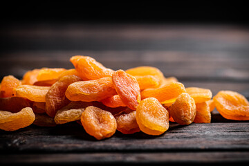 Golden delicious dried apricots on the table.
