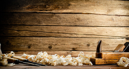 Working tool on wood on with shavings. 