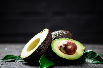Cut ripe avocado with leaves. 