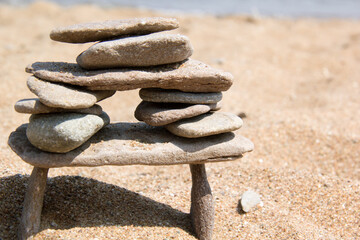 Structure of stones on the beach with ocean on background