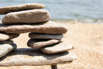 Structure of stones on the beach with ocean on background
