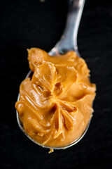 A spoonful full of peanut butter. 