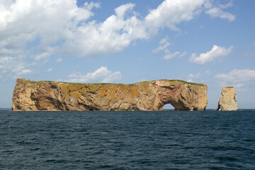 Fototapeta na wymiar Roché Percé, a natural hole in a huge rock in the ocean