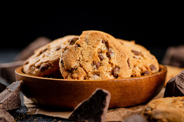 Delicious cookies with pieces of milk chocolate on a plate.