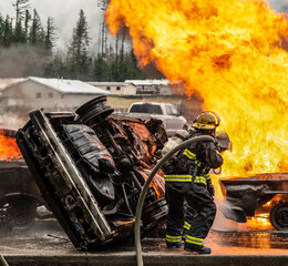 Firefighters extinguish car fire.