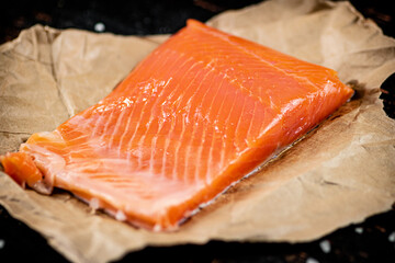 A piece of salted salmon on paper. 