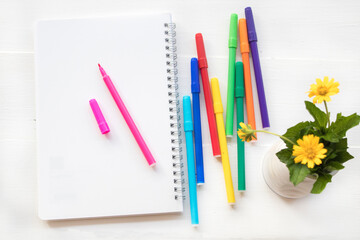 Obraz premium notebook , crayon colorful for drawing arrangement flat lay style on background white 