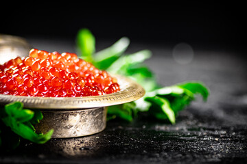Full bowl of red caviar on the table. 