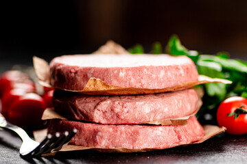 Raw burger with tomatoes and parsley. 