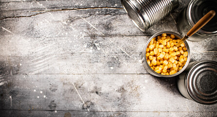 An open can of canned corn with a spoon. 