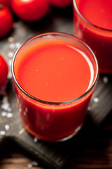 Juice from ripe tomatoes in a glass. 