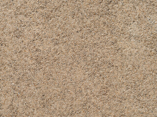 Exposed aggregate concrete wall texture. Empty background pattern of a building facade in East Germany. Architectural design with small stones as plaster.