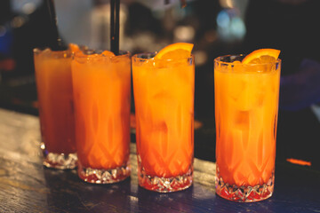 View of alcohol on a party, row line of orange red colored aperitif alcohol cocktails on a party,...