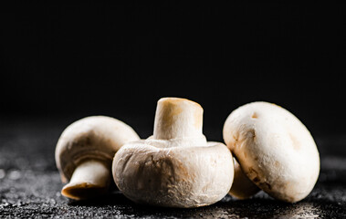 Fresh mushrooms champignons on the table. 