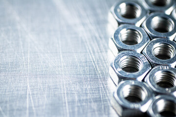 Working tool. Metal nuts on the table. 