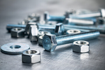 Working tool. Nuts and bolts on the table.  - obrazy, fototapety, plakaty