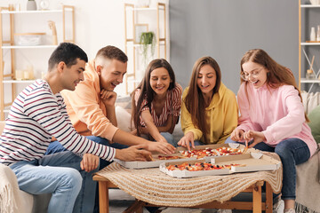 Group of friends with pizza spending time together in living room