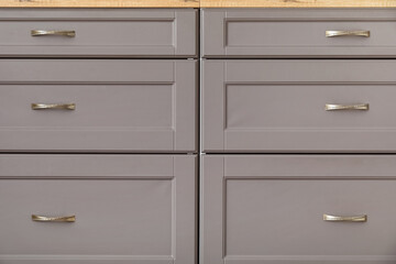 Grey counters with drawers in modern kitchen, closeup