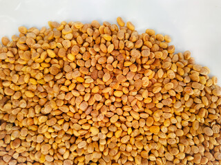 Close up top view of scattered Chironji seeds isolated over white
