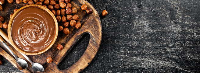 Hazelnut butter on a cutting board with a spoon. 
